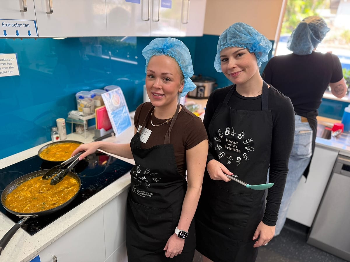 Smart Rentals team members cooking dinner for families at the Townsville Ronald McDonald House